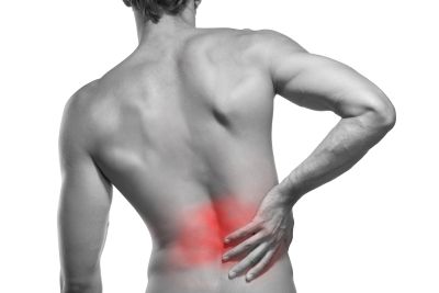 Man holding hand on low back area of pain